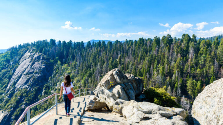 A hiker enjoying the overlooking view from the viewing deck at Moro Rock