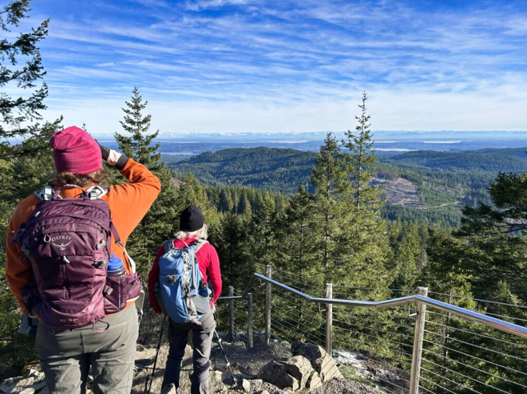 View of the hikers admiring the view from the top of Gold Creek Trail