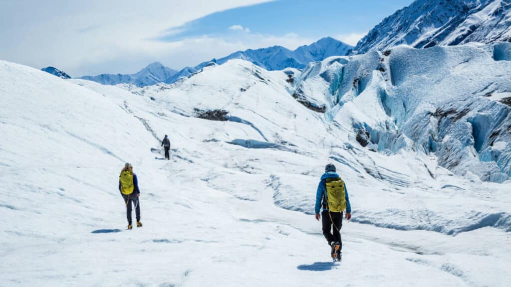 Hikers at the snow covered Matanuska Glacier