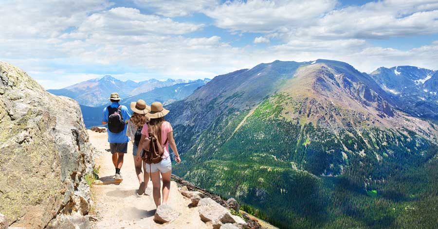 People with their backpack on a hike in Colorado during summer