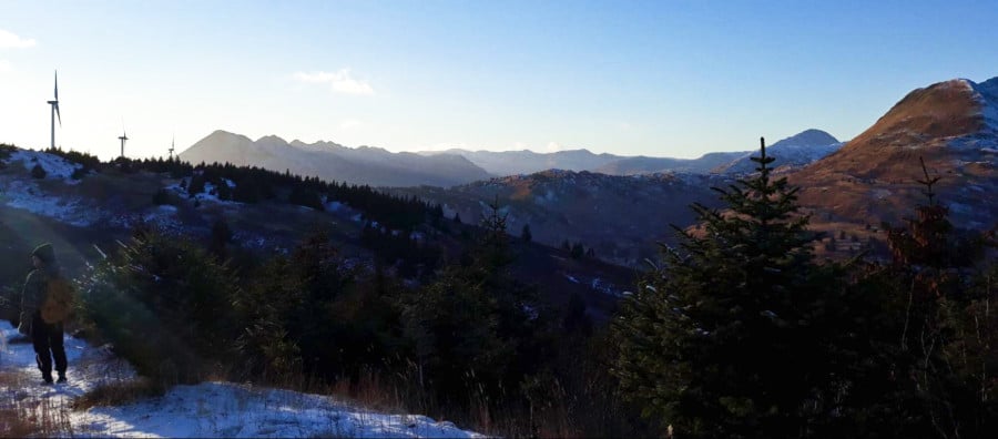 A hiker at the trail to Pillar Mountain in winter