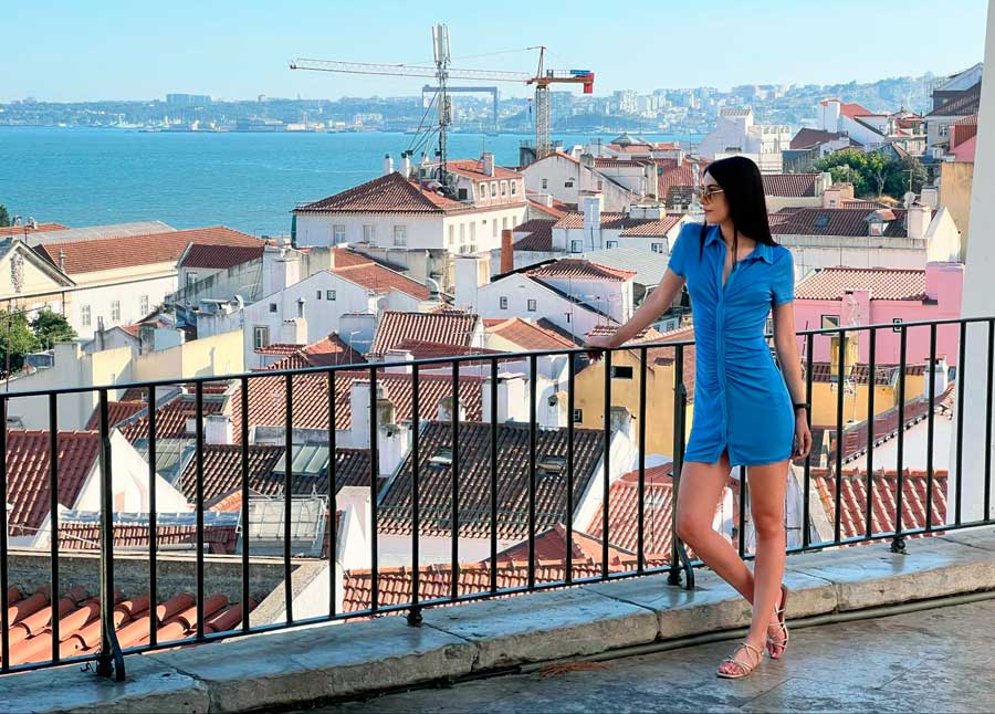 Clara posing for a photo with an overlooking view of Historic Alfama District