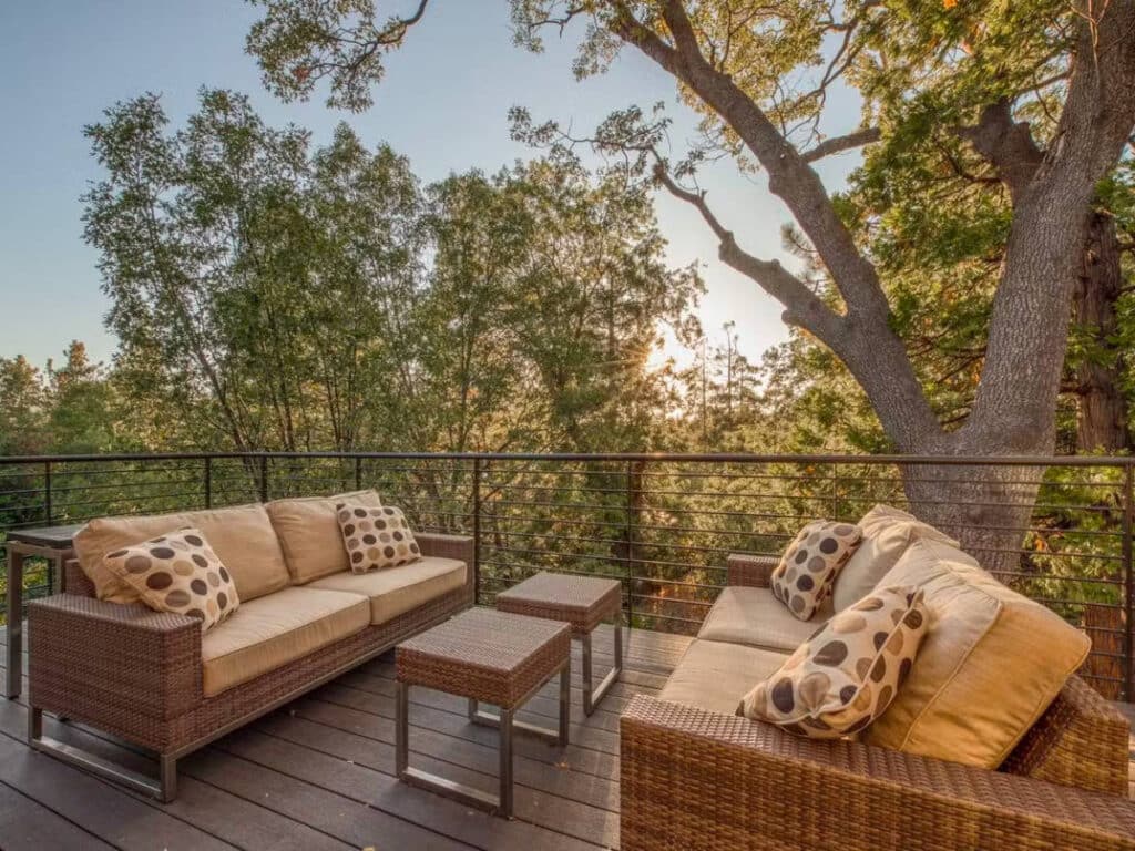Tables and couches on the patio of Hit the Target accommodation