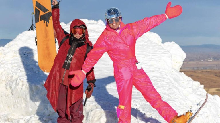 A snowboarder and skier posing for a photo at the Hoedown Hill