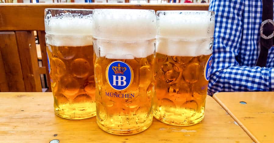 Three glasses of beer lined up on the table