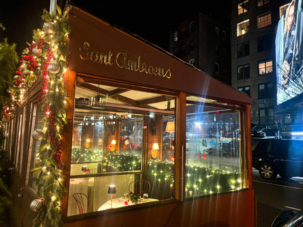 View of the outdoor dining of Sant Ambroeus with holiday decorations around