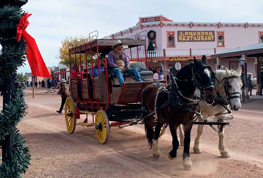 People riding a horse carriage in Tombstone