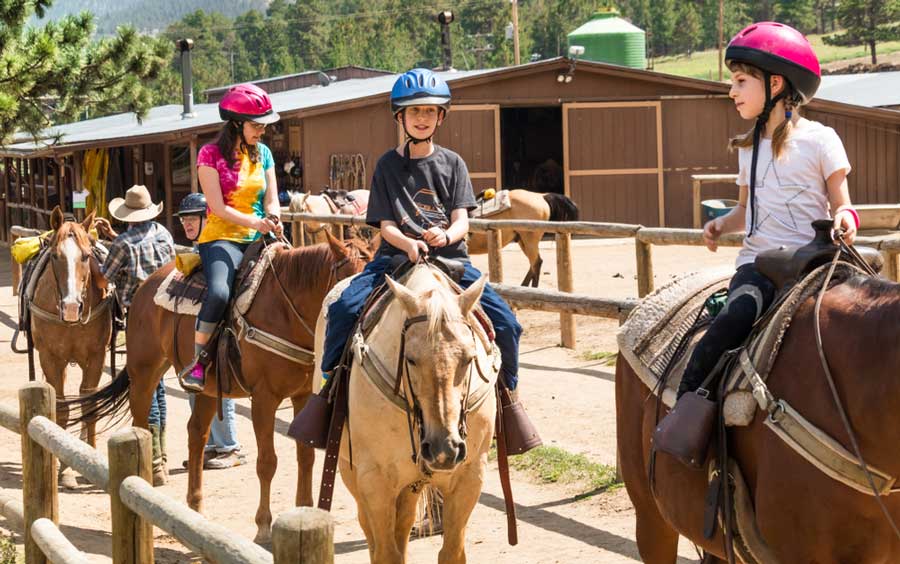 Kids experiencing horseback riding