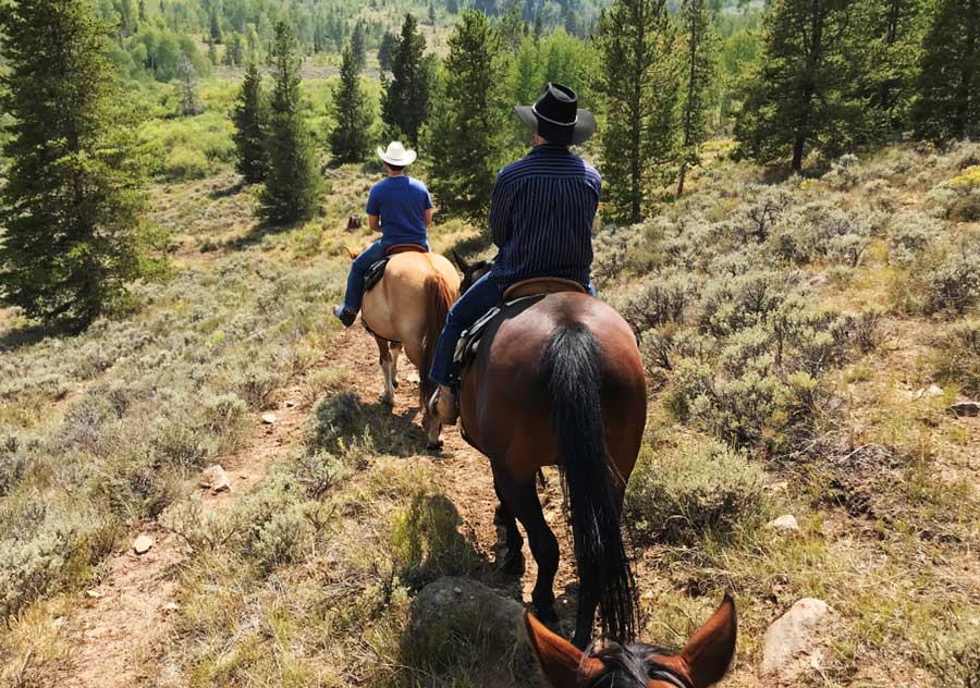View of two cowboys riding their horses in Silverton