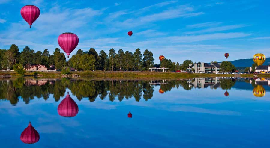 Colorful hot air balloons floating up in the sky of Pagosa Springs