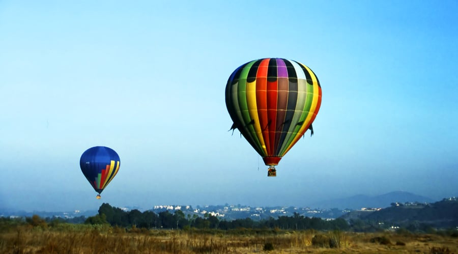 View of hot air balloons floating high above in Del Mar