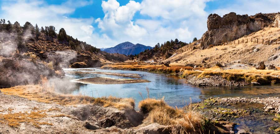 A natural hot spring in the middle of a stunning view of the valley.