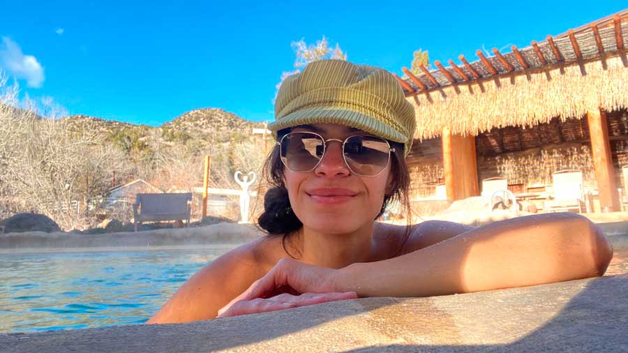 The author enjoying her day under the clear blue sky on a hot spring resort