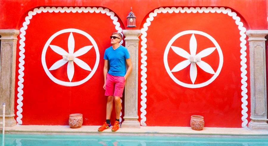 Travel Lemming founder Nate Hake against the vibrant wall in Hotel Quinta Marciala