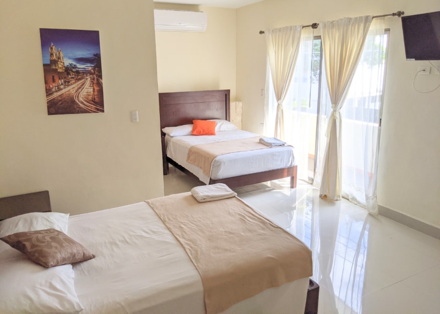 Beds in a room at the Hotel Casa Rosario