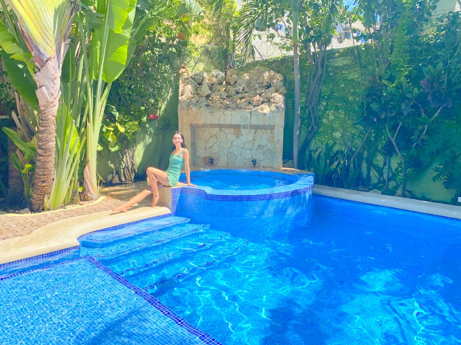 Clara posing for a picture near the pool in Hotel Luna Sol