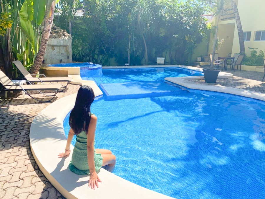 Clara soaking her feet on the pool in Hotel Luna Sol