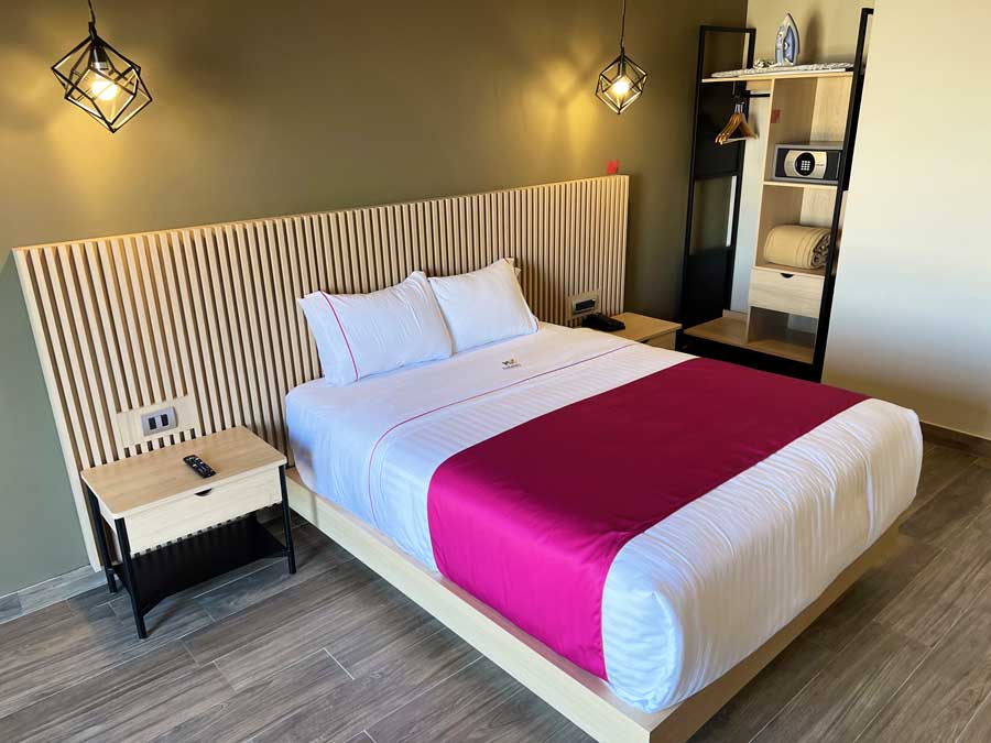 View of a bed in Hotel MX Bedroom