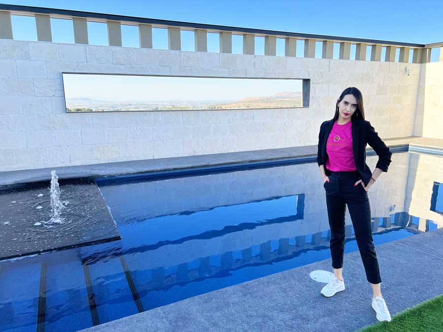 Clara standing beside the pool in Hotel MX
