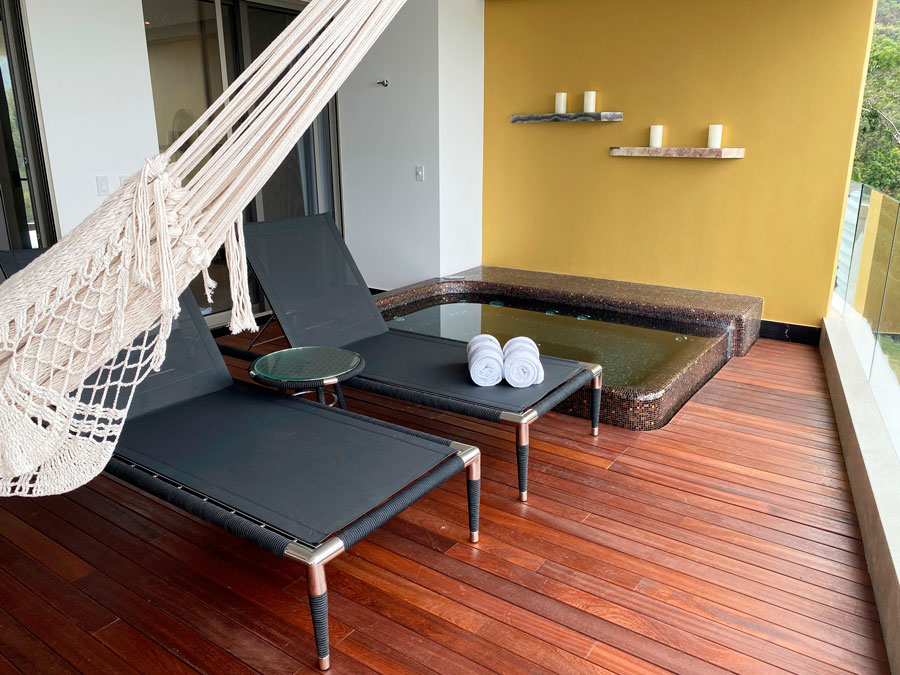 View of chairs and a hammock on a balcony in Hotel Mousai