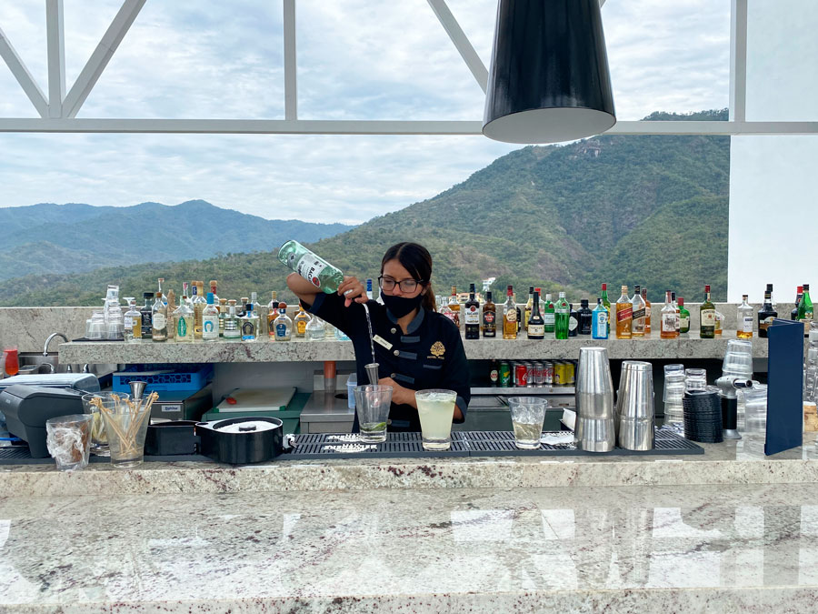 A bartender preparing a drink in Hotel Mousai