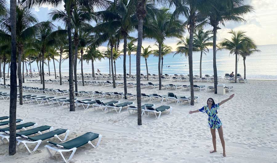 Clara posing for a photo on the beachside of Hotel Riu Yucatan