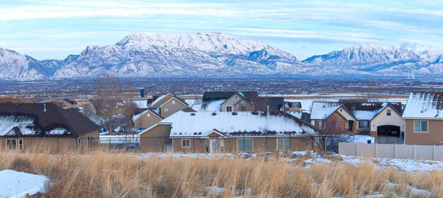 Panoramic view of the houses with the snow covered mountains in the background