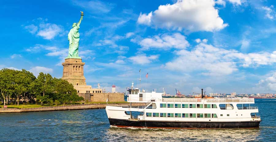 A tourist ship passing by the Statue of Liberty