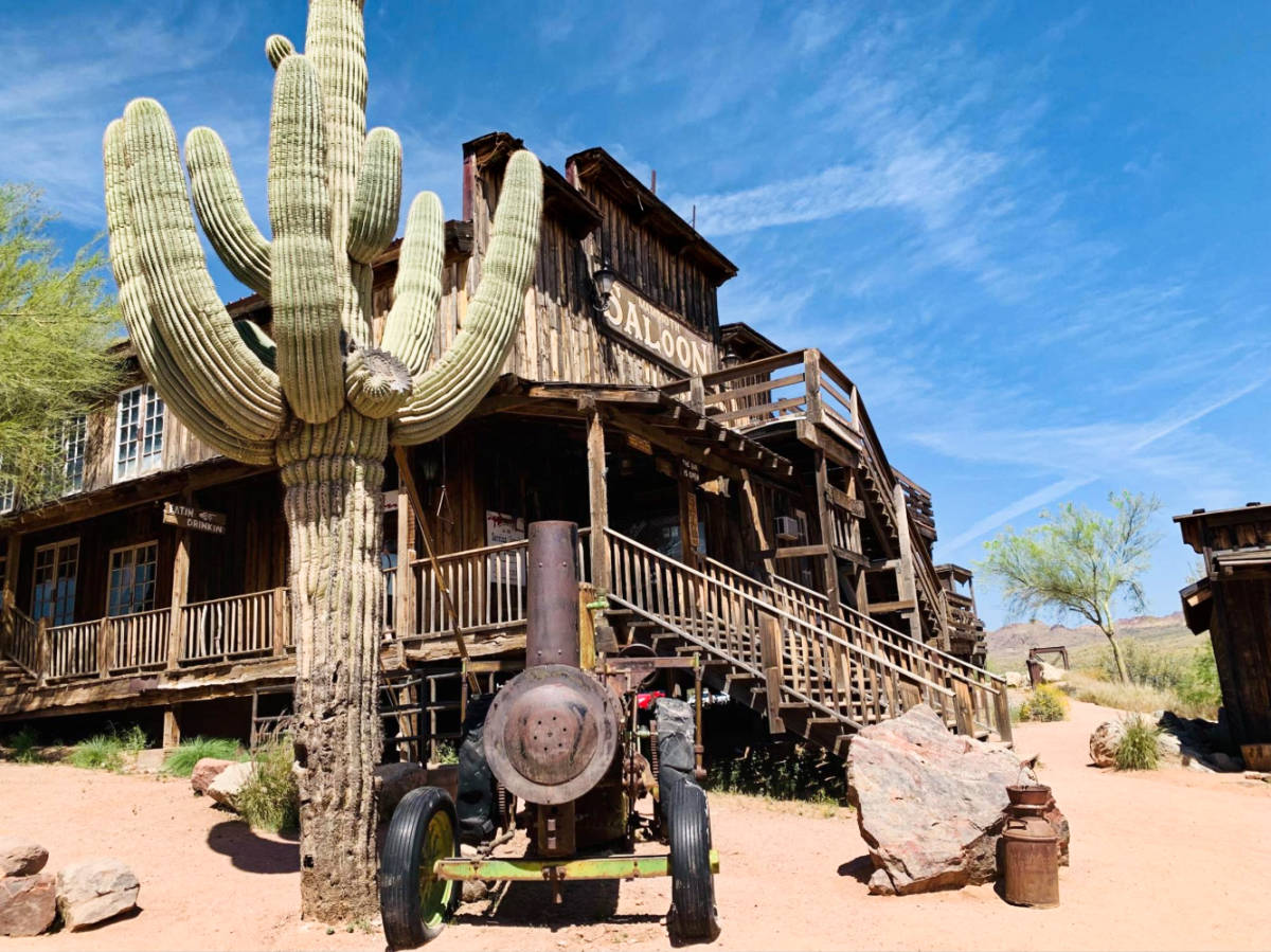A huge cacti and a tank outside a saloon at Goldfield Ghost Town
