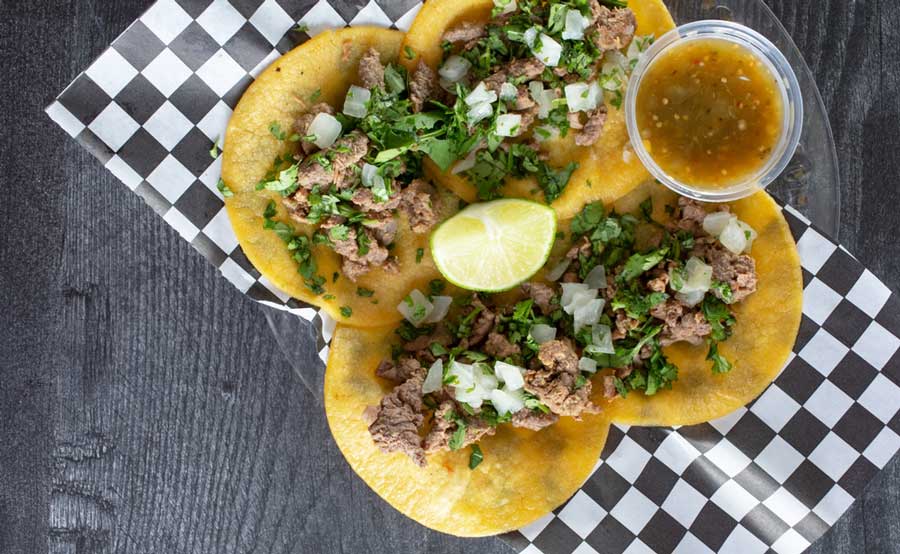 View of tacos with dip on a plate at Hunger Street Tacos