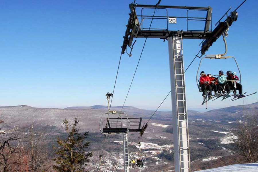 Skiers on a lift in Hunter Mountain