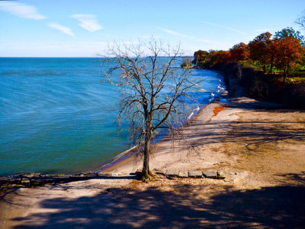 View of the fall foliage and the calm ocean water from the Huntington Beach in Bay Village