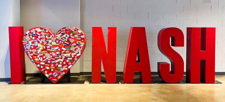 A big red sign of I "heart" NASH with flags of different countries on the heart