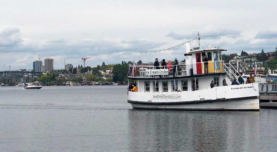 The Ice Cream Cruise with people on board pulling into the dock in Seattle