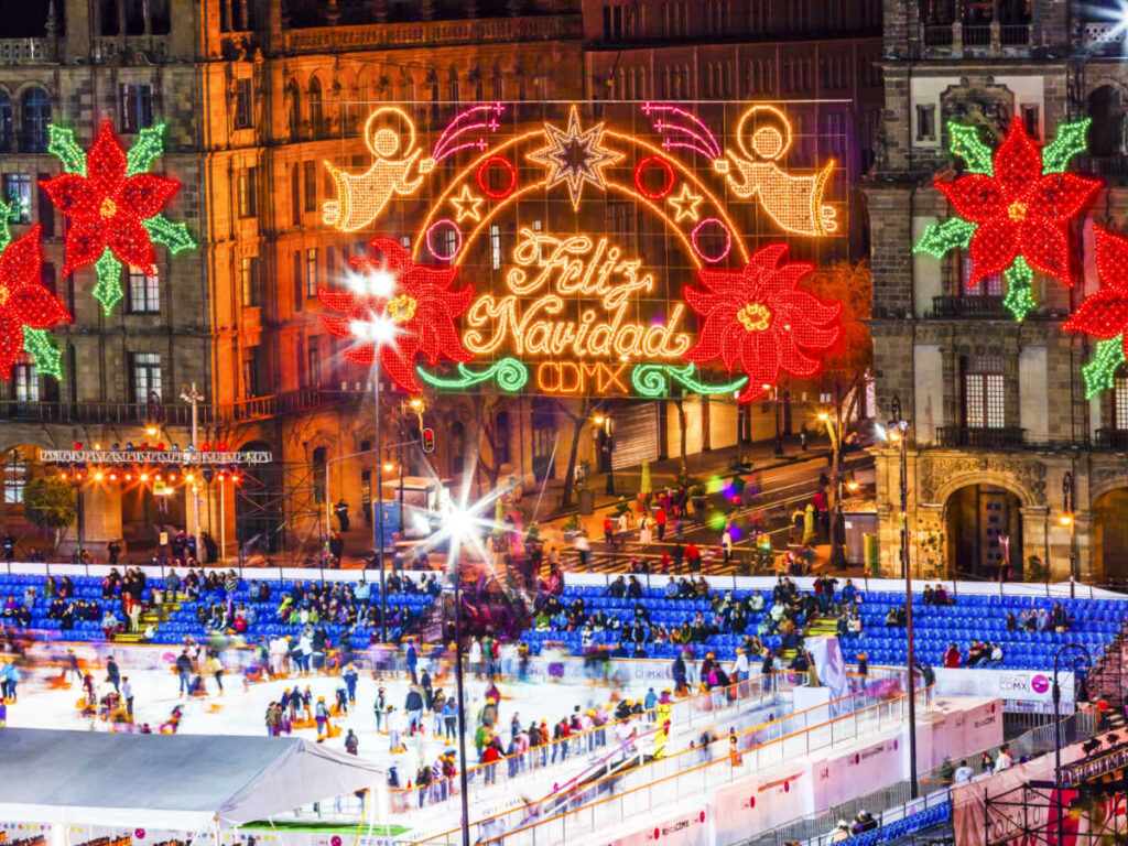 The people enjoying at the ice skating rating with Christmas decor around