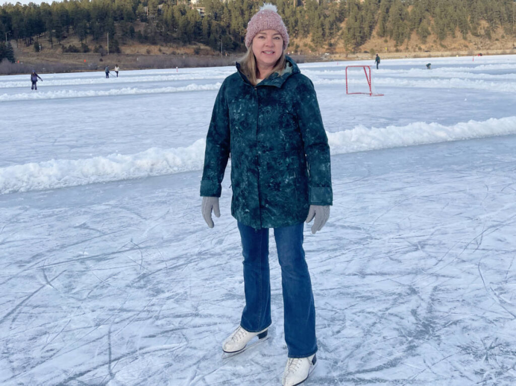 The author, Laura Falin ice skating in Evergreen Lake