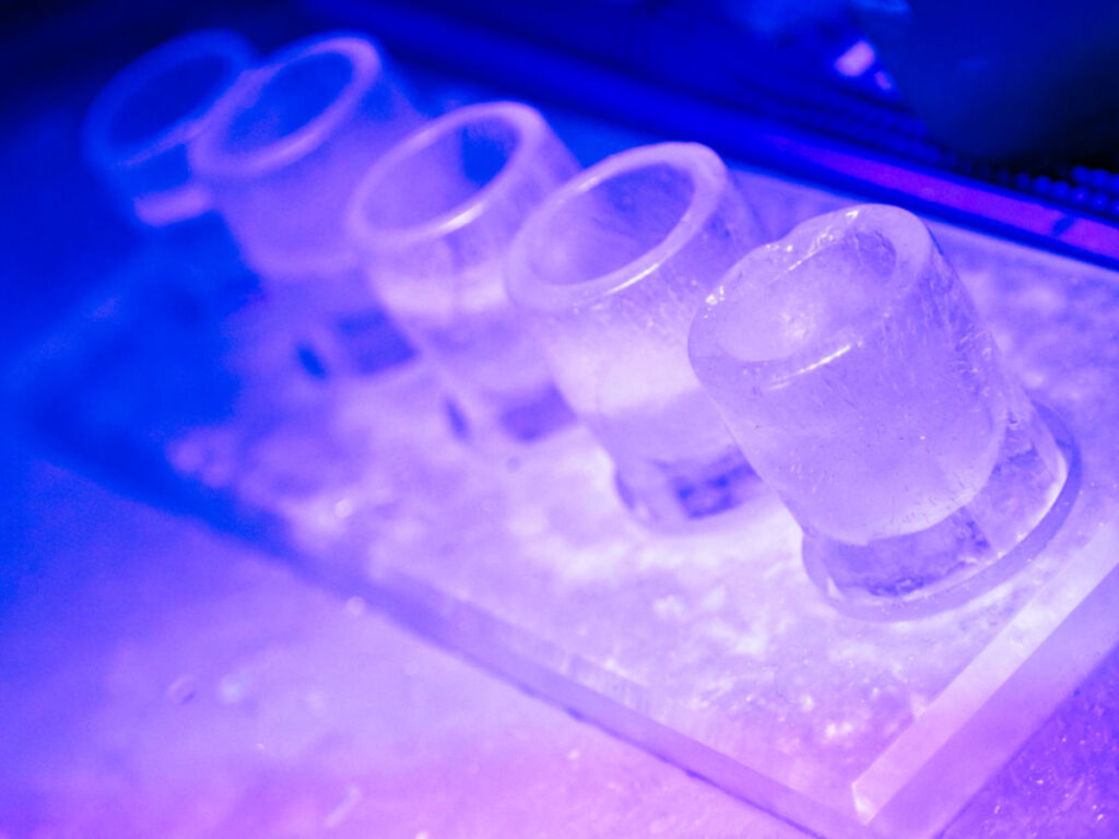 Shot glasses made of ice on a bar