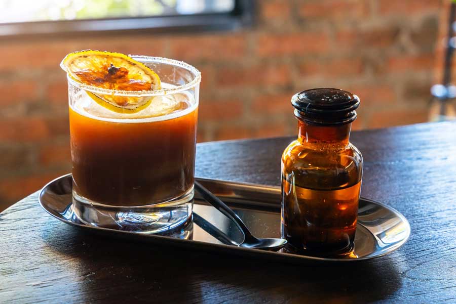An iced black americano with sliced of orange on top