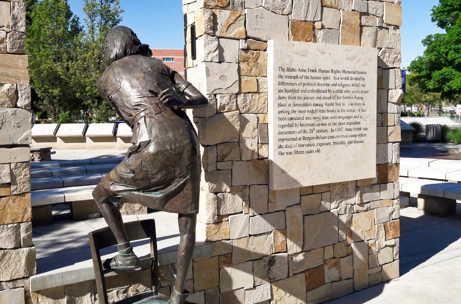 A sculpture of Anne Frank beside a display of quotes outside Idaho Anne Frank Human Rights Memorial