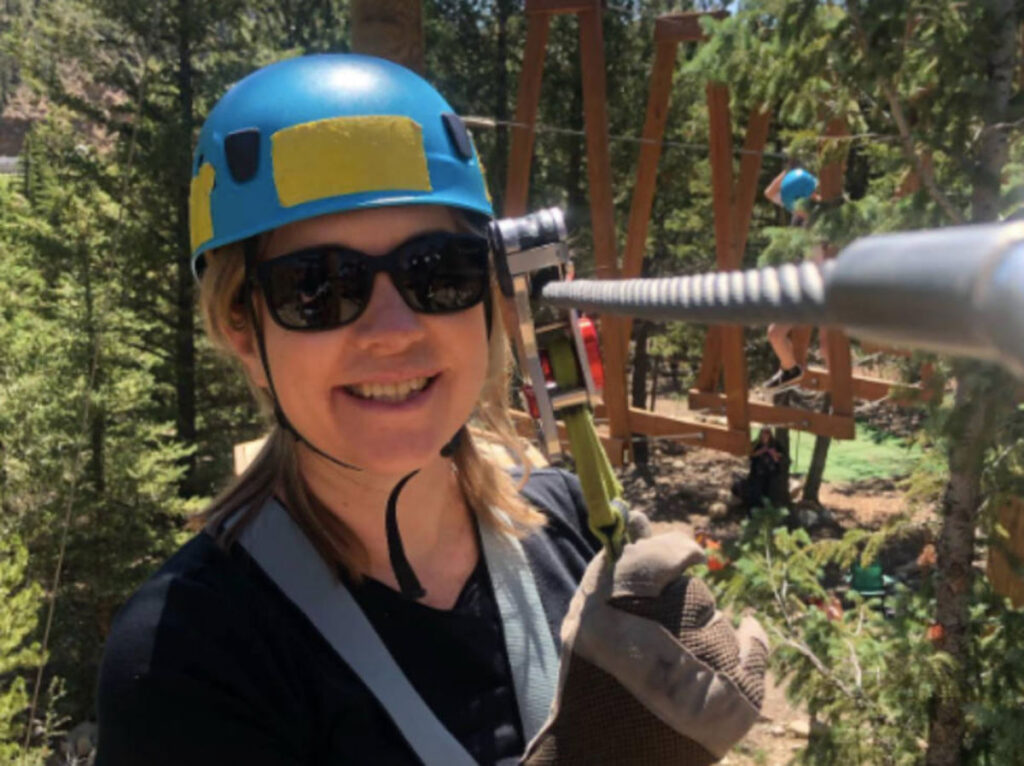 The author, Laura Falin smiling for a photo at the Idaho Springs Ropes Course