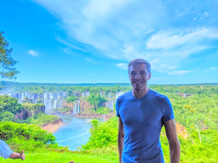Nate Hake posing with Iguazu Falls in background