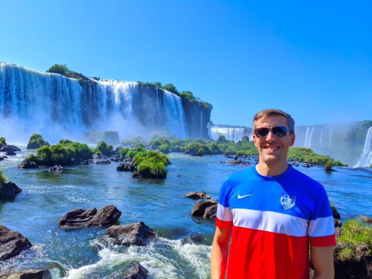 Nate Hake in a US soccer jersey at Iguazu Falls on the Brazil side