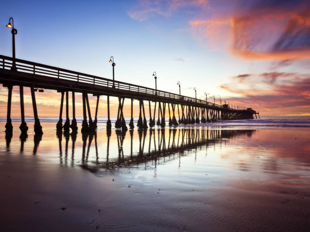 View of the long boardwalk at Imperial Beach at dusk