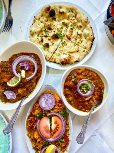 A plate of naan and different homemade dishes from City Spice
