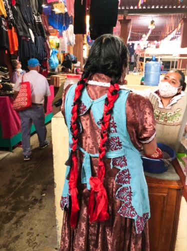 A market vendor dressed in traditional dress