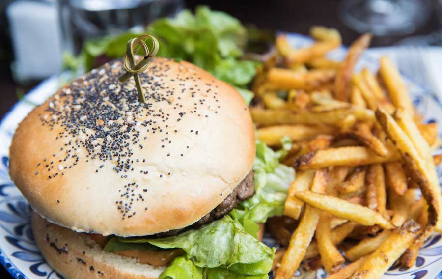 Close up view of a burger and a fries in Ingo’s Tasty Food