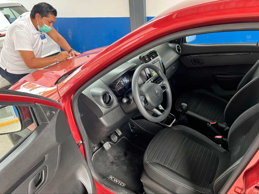 A man inspecting a rental car