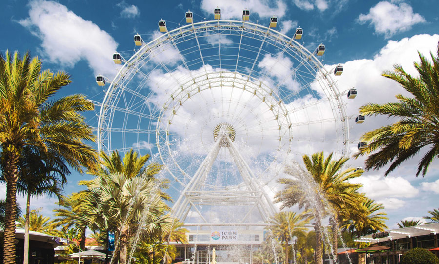 View of a ferris wheel from afar and the clear blue sky on the background