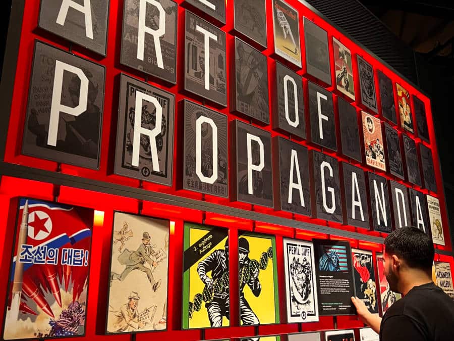 A man checking out art gallery of The Art of Propaganda