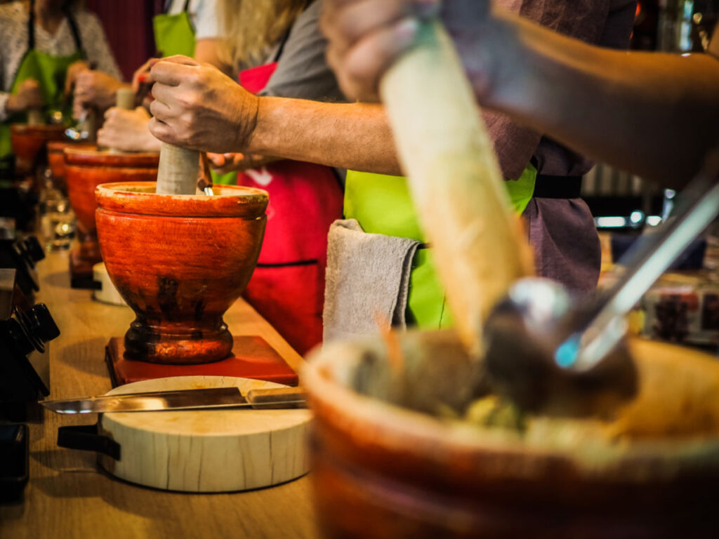 Preparing Spicy Thai papaya salad at a cooking class in Thailand